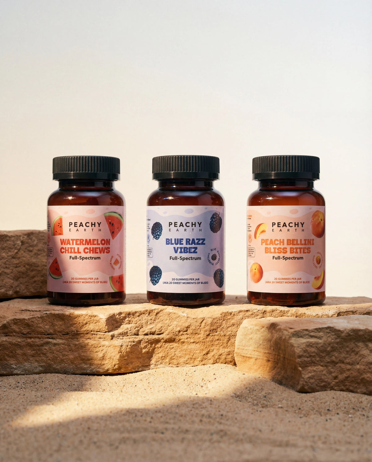 Peachy Earth hemp gummies in three flavors arranged on natural stone